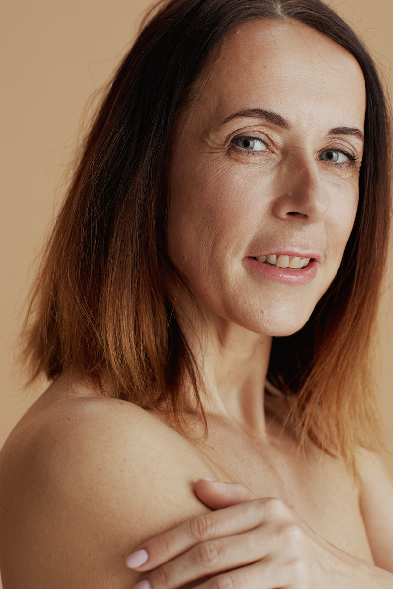 modern 40 years old woman isolated on beige background